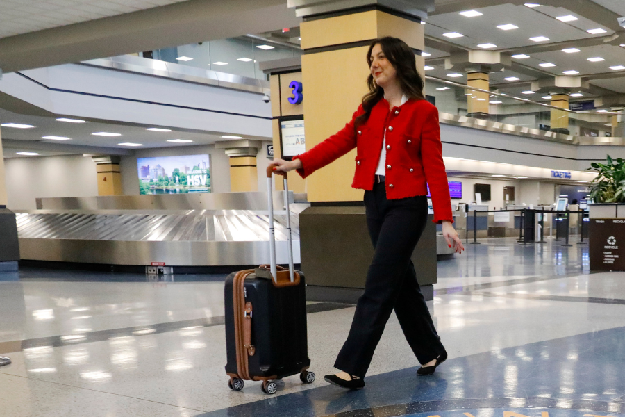 Women traveling through HSV with suitcase